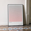 A framed Die Hard movie script poster leaning against a wall in a minimalist interior.