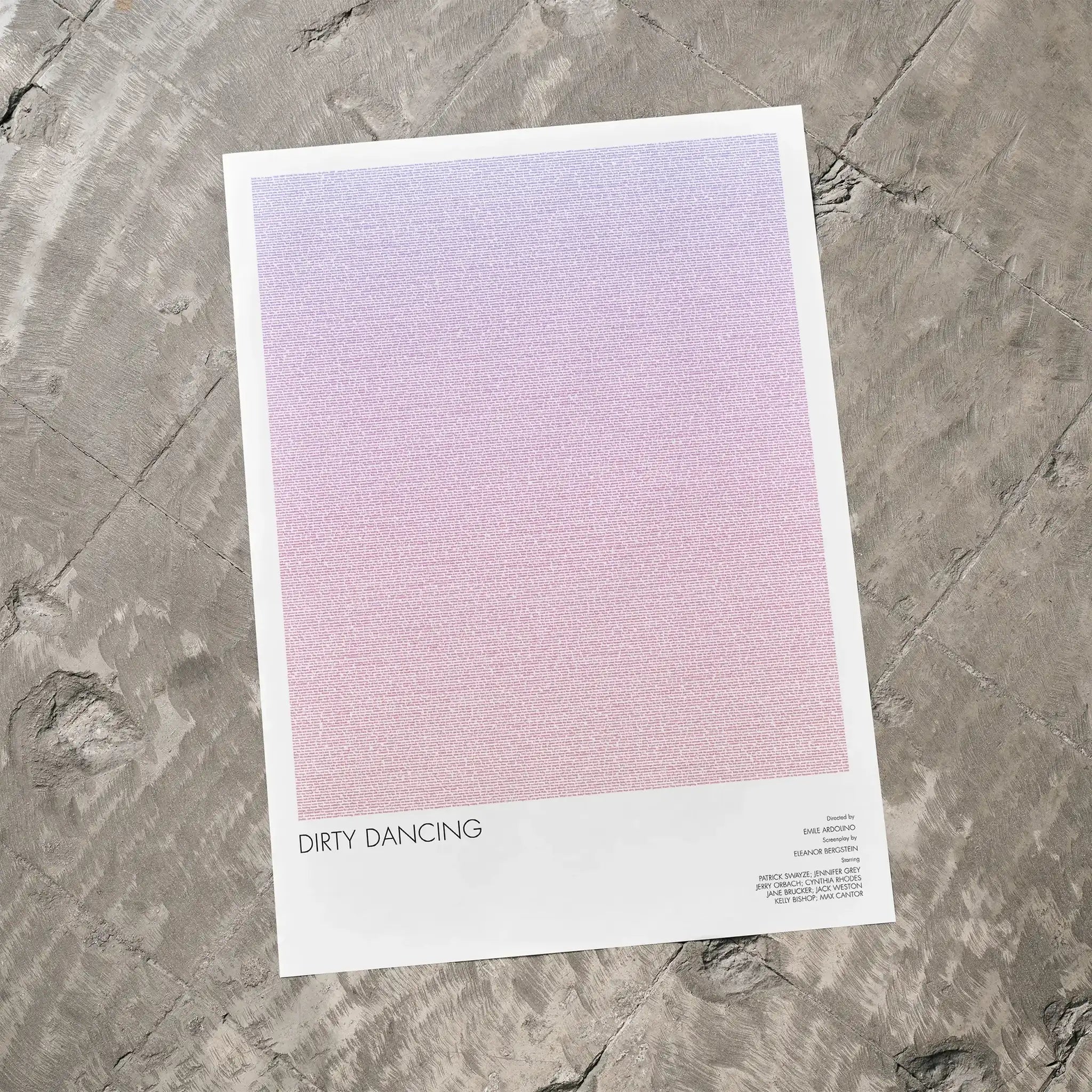A Dirty Dancing movie script poster laid flat on a textured floor surface.