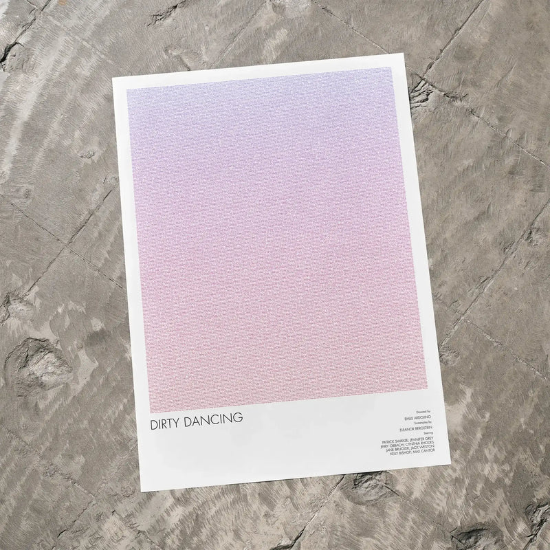 A Dirty Dancing movie script poster laid flat on a textured floor surface.
