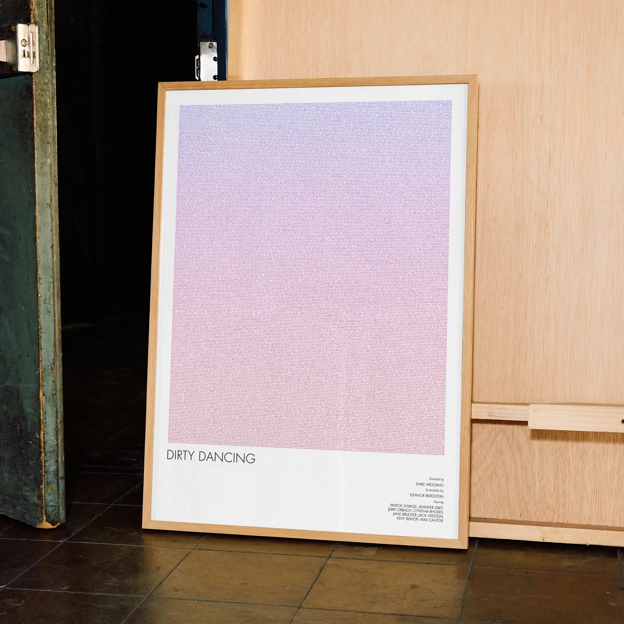 A framed Dirty Dancing movie script poster displayed in a contemporary interior setting.