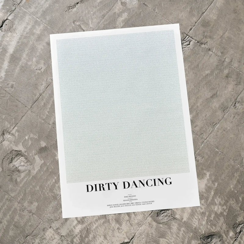 A Dirty Dancing movie script poster laid flat on a textured floor surface.