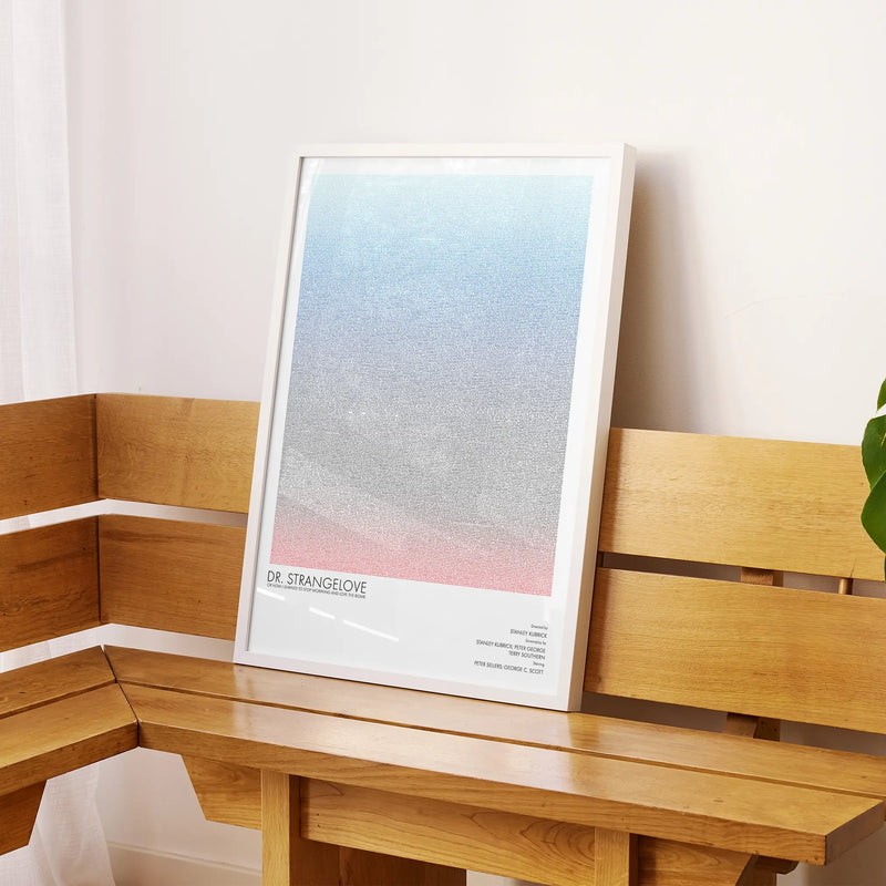 A framed Dr. Strangelove or: How I Learned to Stop Worrying and Love the Bomb movie script poster displayed on a sideboard in a contemporary space.