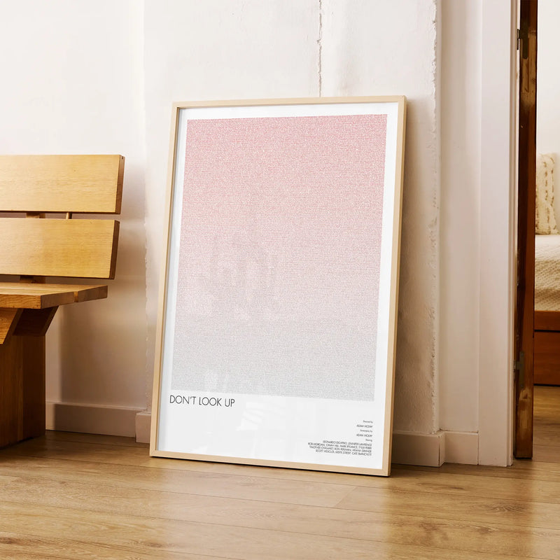 A framed Don't Look Up movie script poster arranged in a minimalist interior setting.