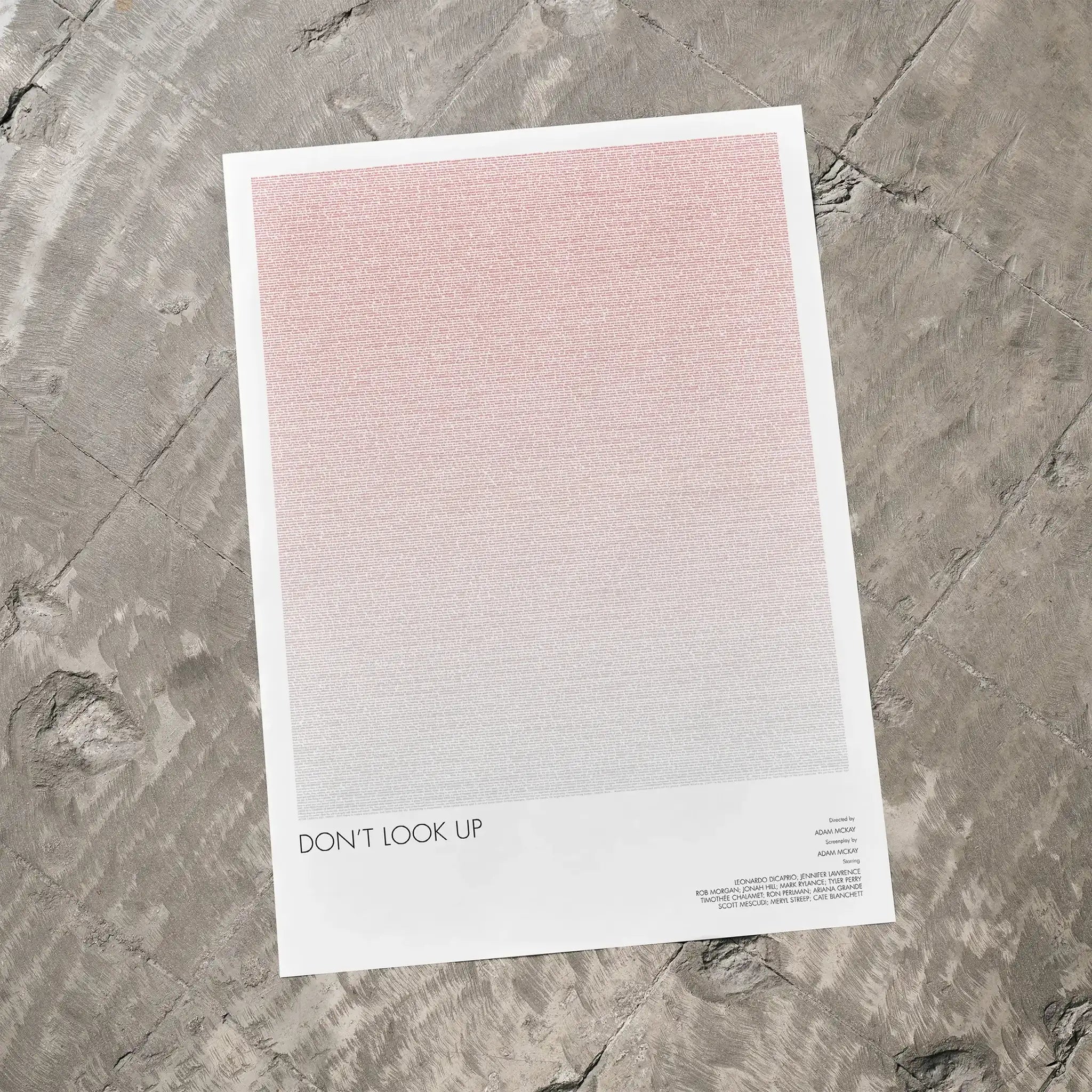 A Don't Look Up movie script poster laid flat on a textured floor surface.