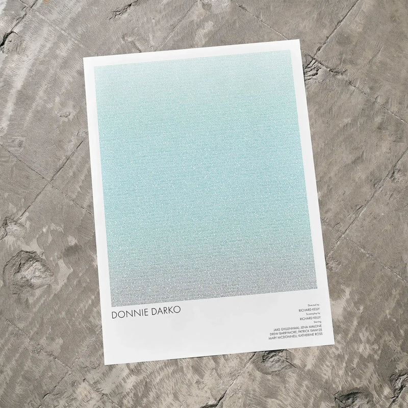 A Donnie Darko movie script poster laid flat on a textured floor surface.
