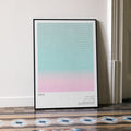 A framed Drive movie script poster leaning against a wall in a minimalist interior.