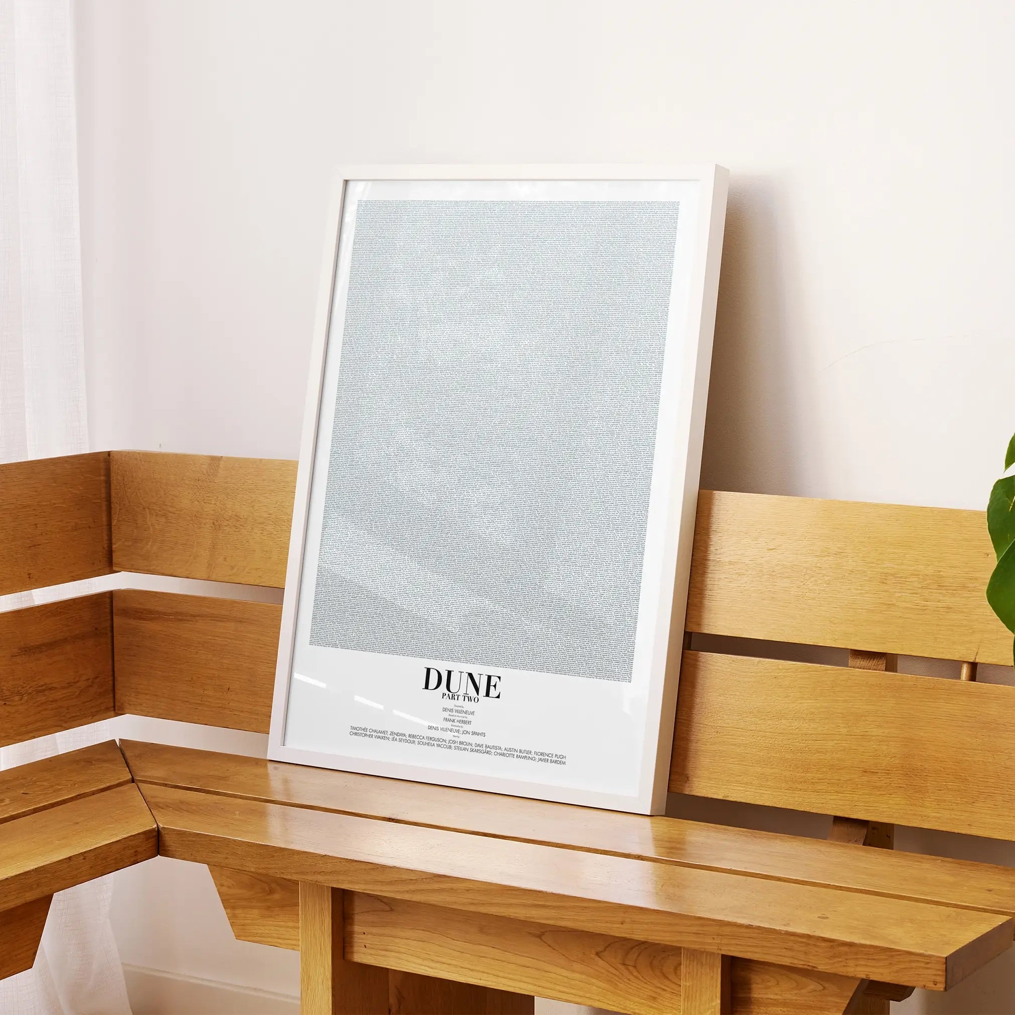 A framed Dune: Part Two movie script poster displayed on a sideboard in a contemporary space.