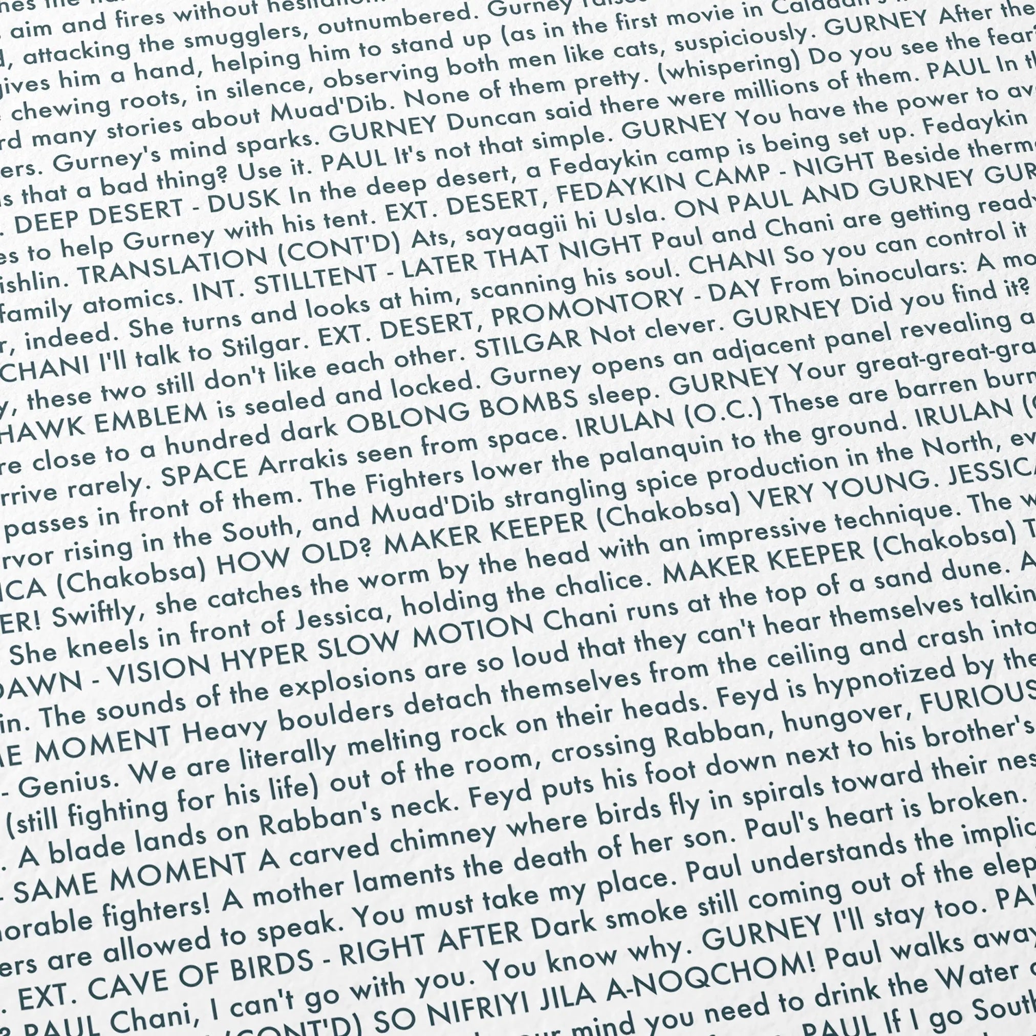 Close-up detail of the Dune: Part Two movie script poster showing dense typographic text.