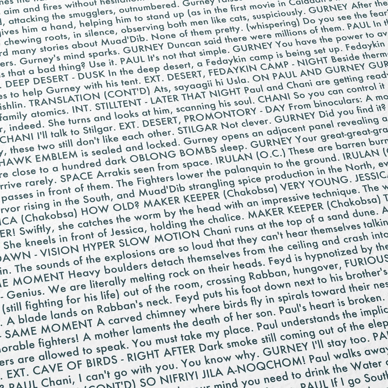 Close-up detail of the Dune: Part Two movie script poster showing dense typographic text.