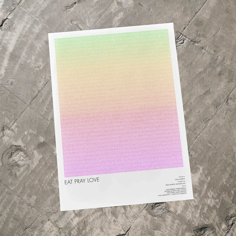 A Eat Pray Love movie script poster laid flat on a textured floor surface.