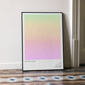 A framed Eat Pray Love movie script poster leaning against a wall in a minimalist interior.
