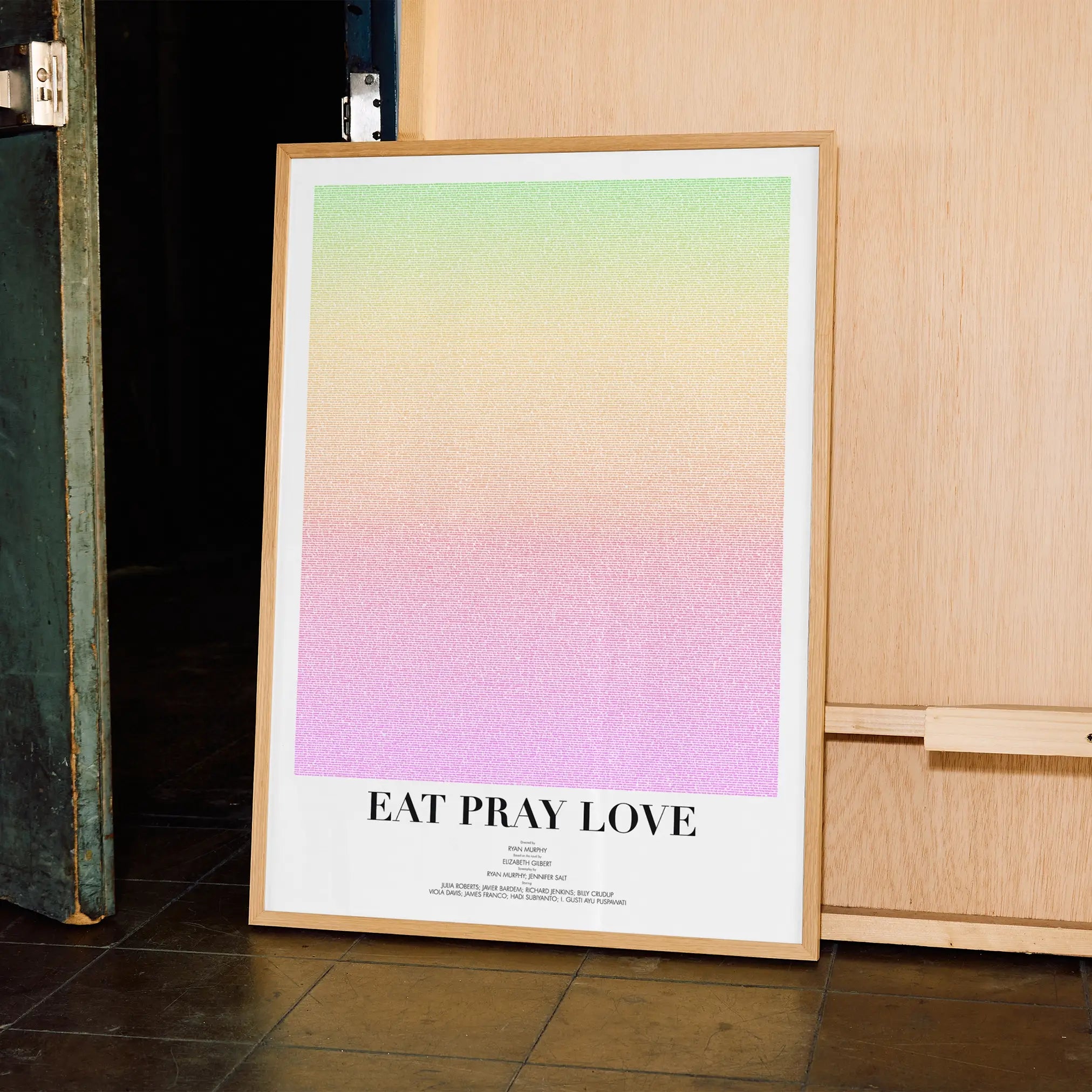 A framed Eat Pray Love movie script poster displayed in a contemporary interior setting.