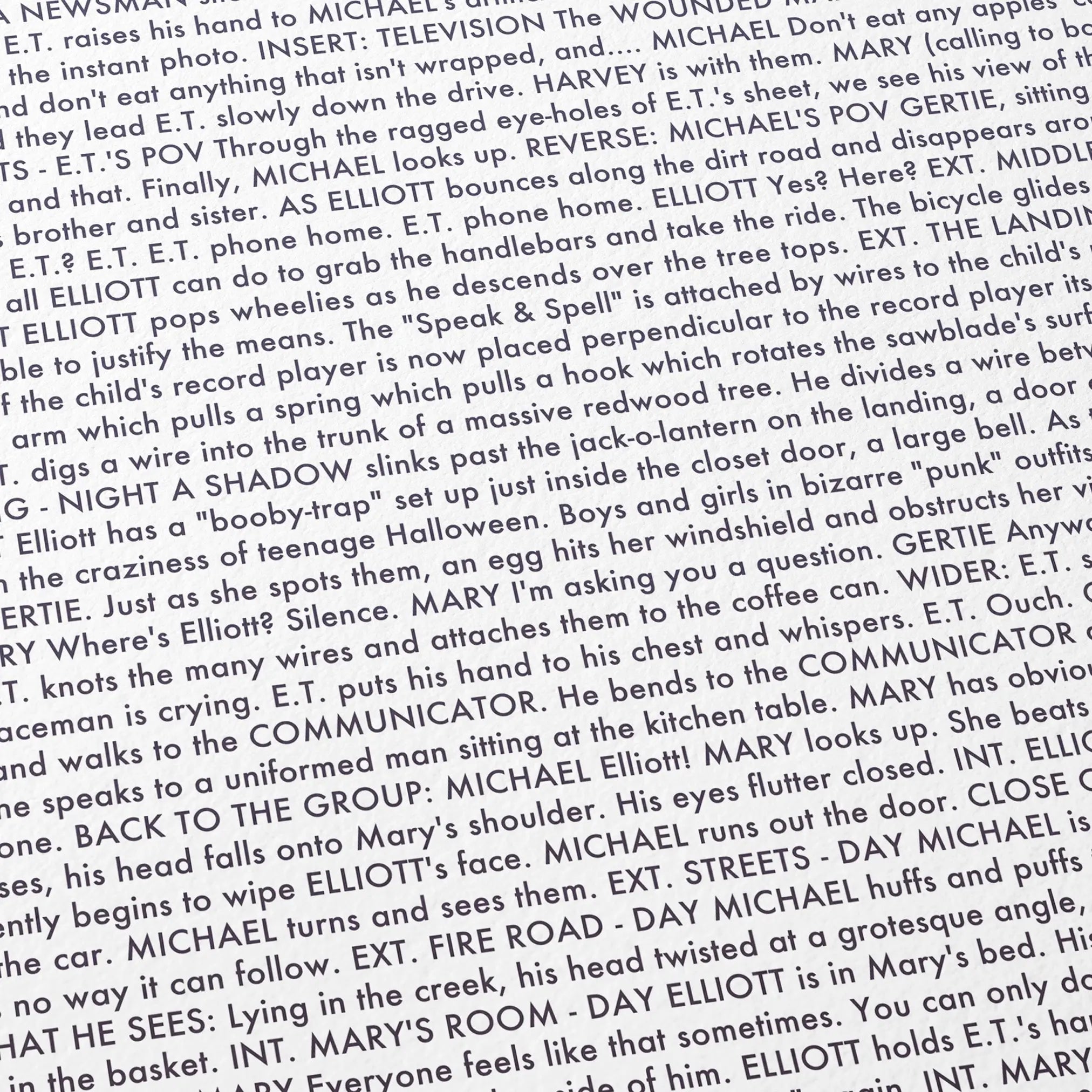 Close-up detail of the E.T. the Extra-Terrestrial movie script poster showing dense typographic text.