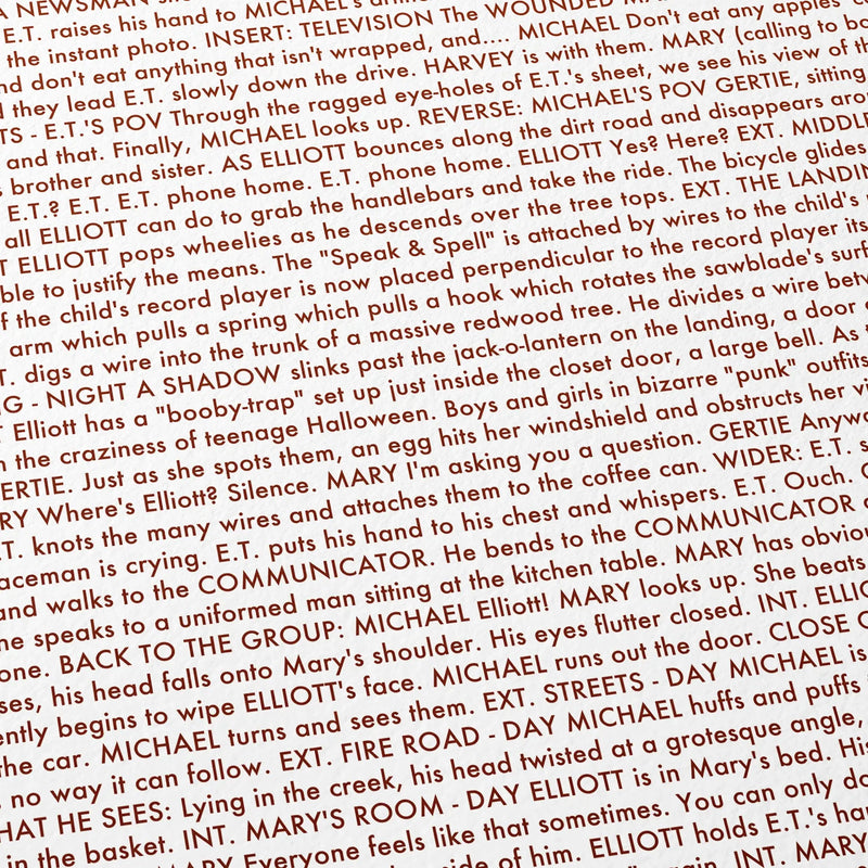Close-up detail of the E.T. the Extra-Terrestrial movie script poster showing dense typographic text.