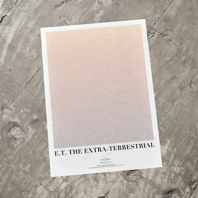 A E.T. the Extra-Terrestrial movie script poster laid flat on a textured floor surface.