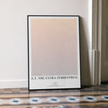 A framed E.T. the Extra-Terrestrial movie script poster leaning against a wall in a minimalist interior.