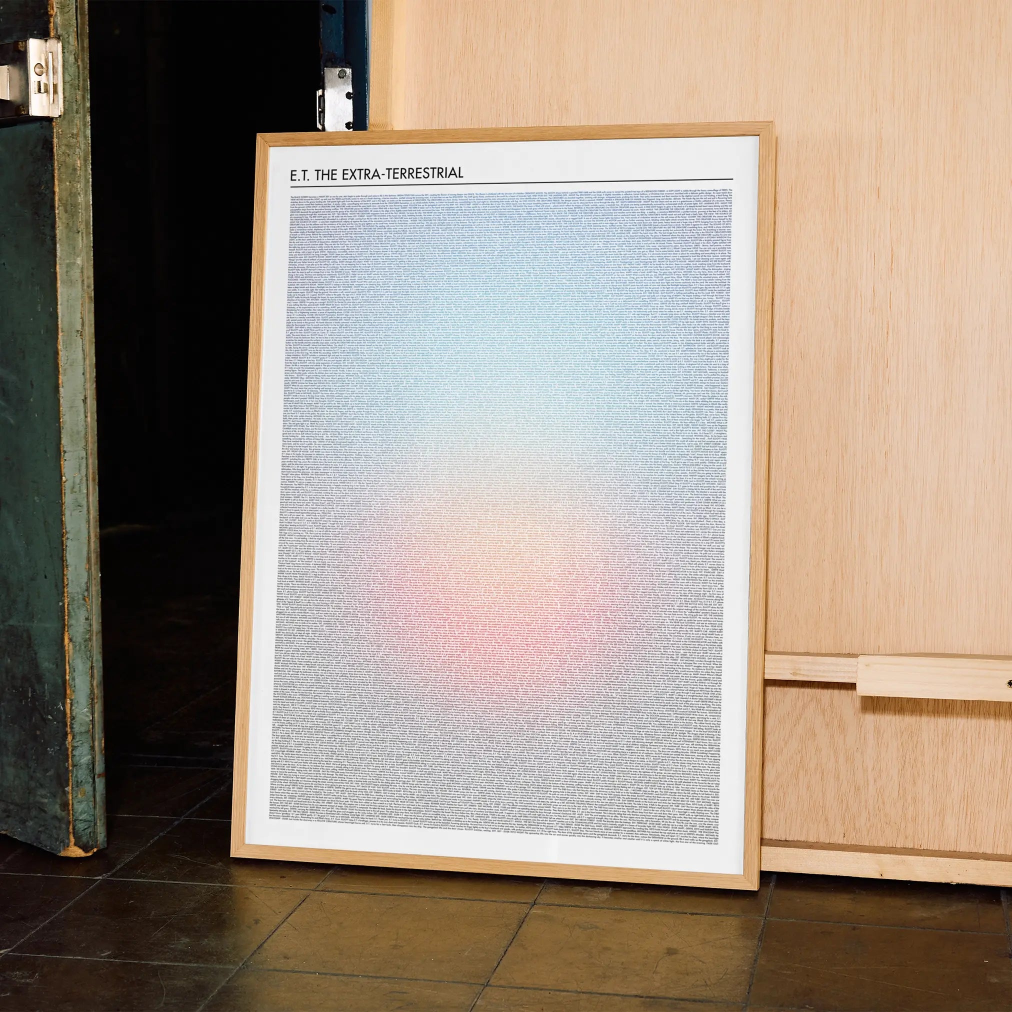 A framed E.T. the Extra-Terrestrial movie script poster displayed in a contemporary interior setting.