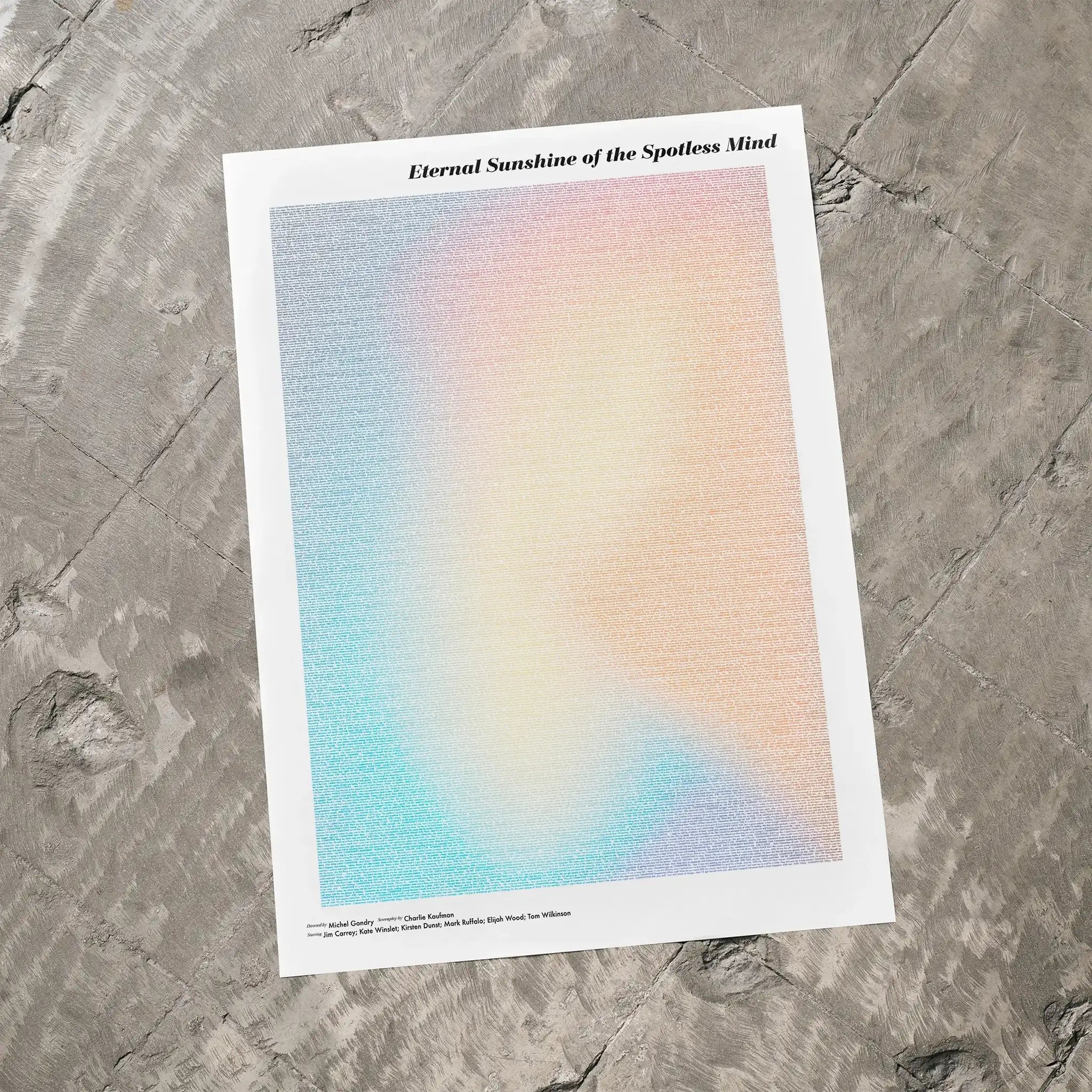 A Eternal Sunshine of the Spotless Mind movie script poster laid flat on a textured floor surface.