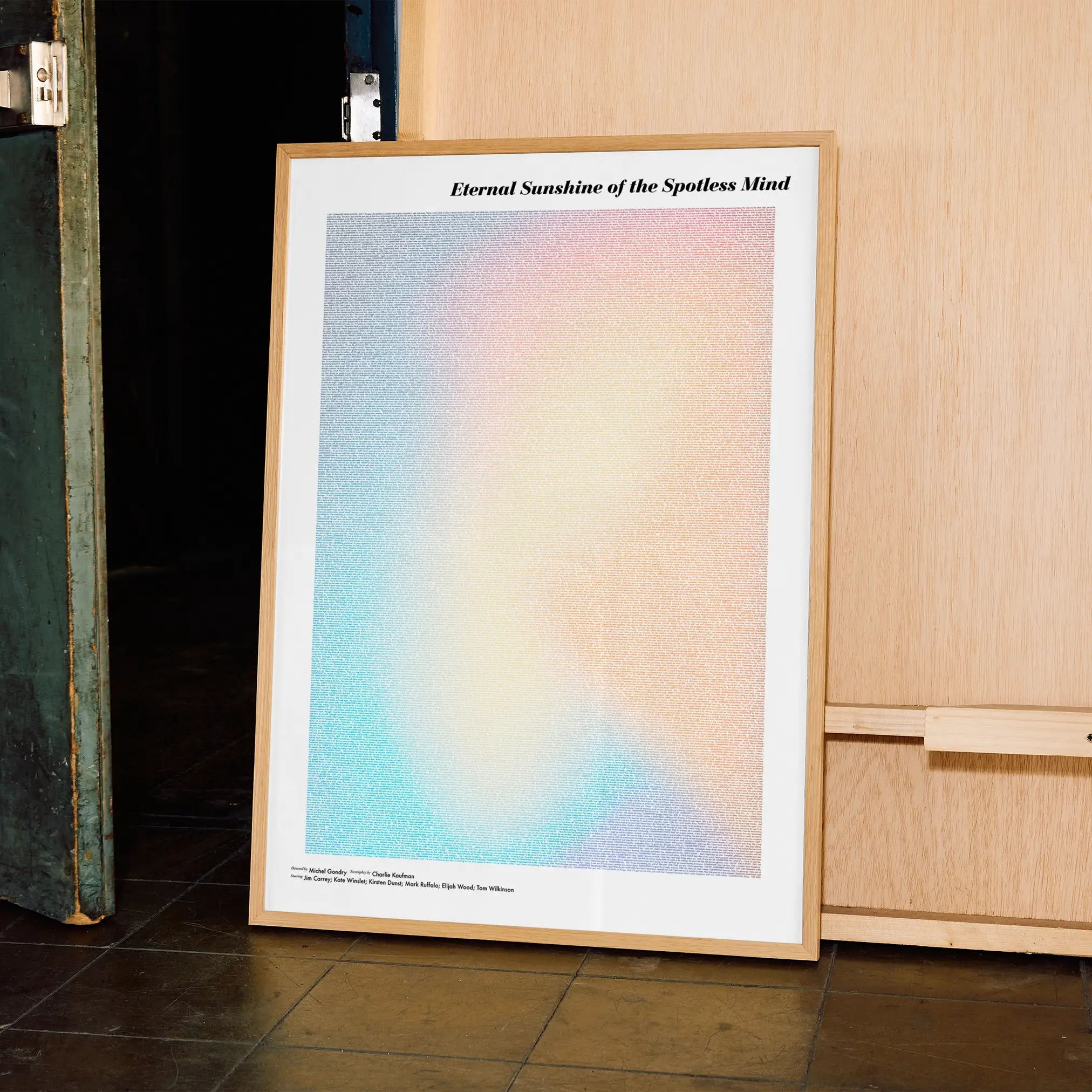 A framed Eternal Sunshine of the Spotless Mind movie script poster displayed in a contemporary interior setting.