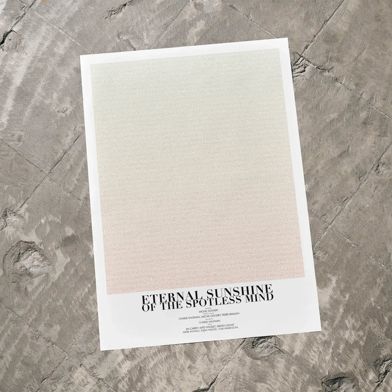 A Eternal Sunshine of the Spotless Mind movie script poster laid flat on a textured floor surface.