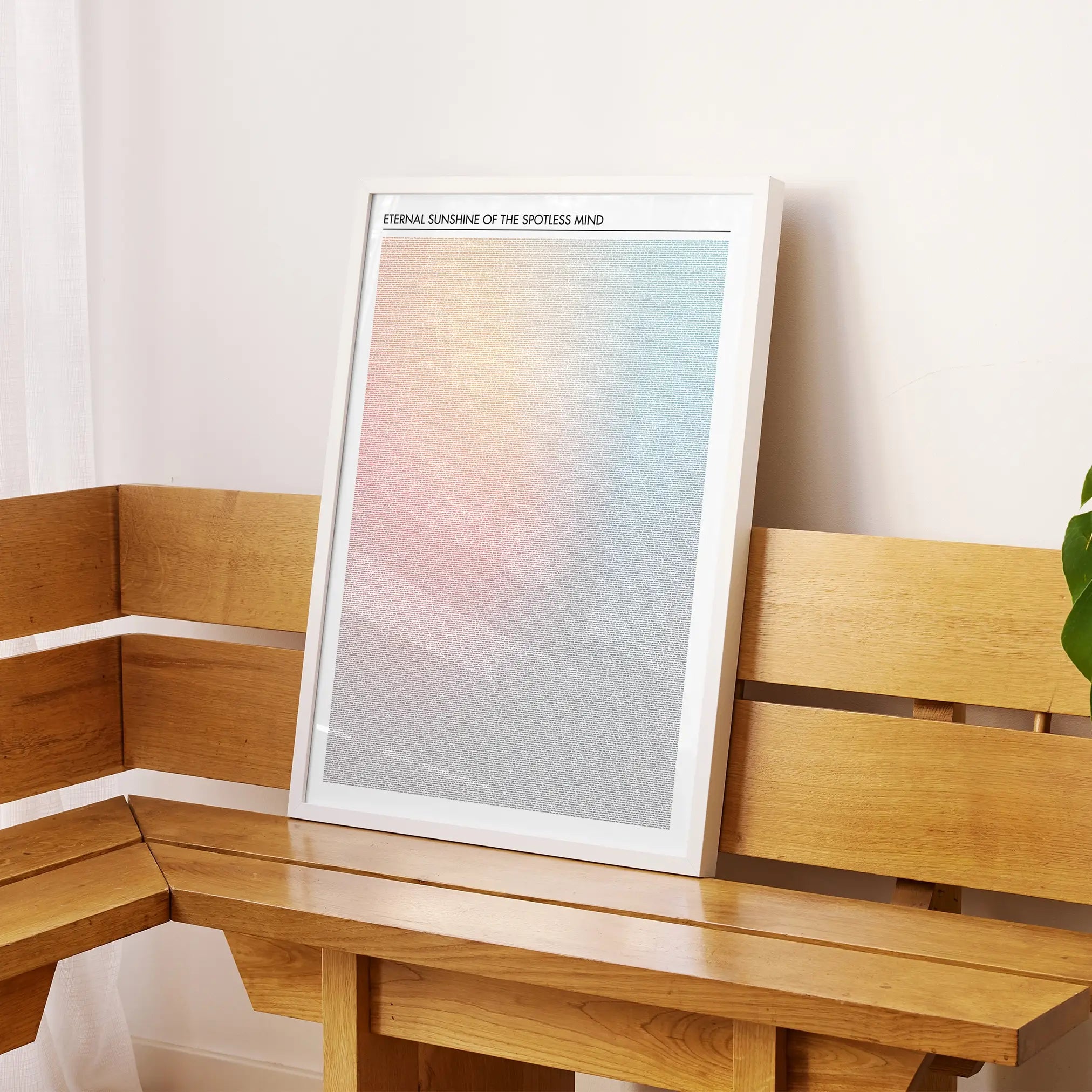 A framed Eternal Sunshine of the Spotless Mind movie script poster displayed on a sideboard in a contemporary space.