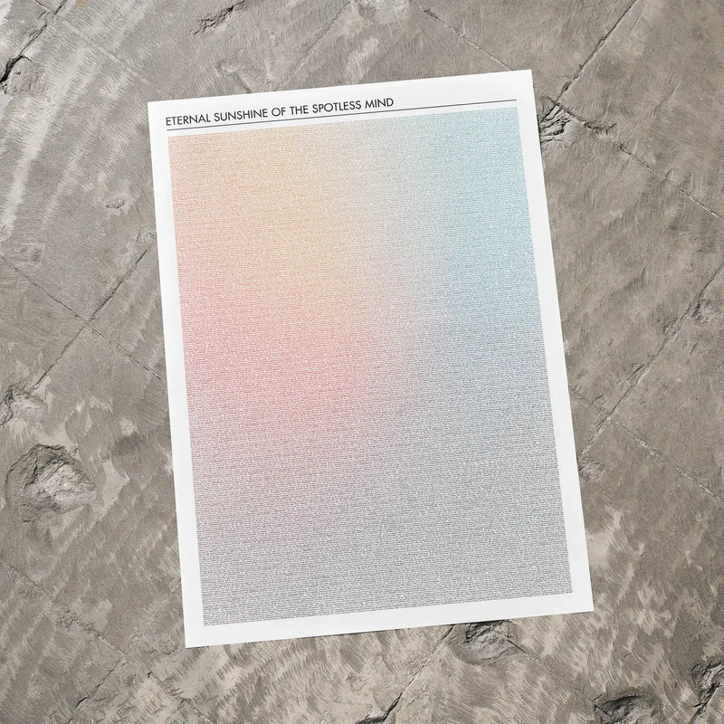 A Eternal Sunshine of the Spotless Mind movie script poster laid flat on a textured floor surface.