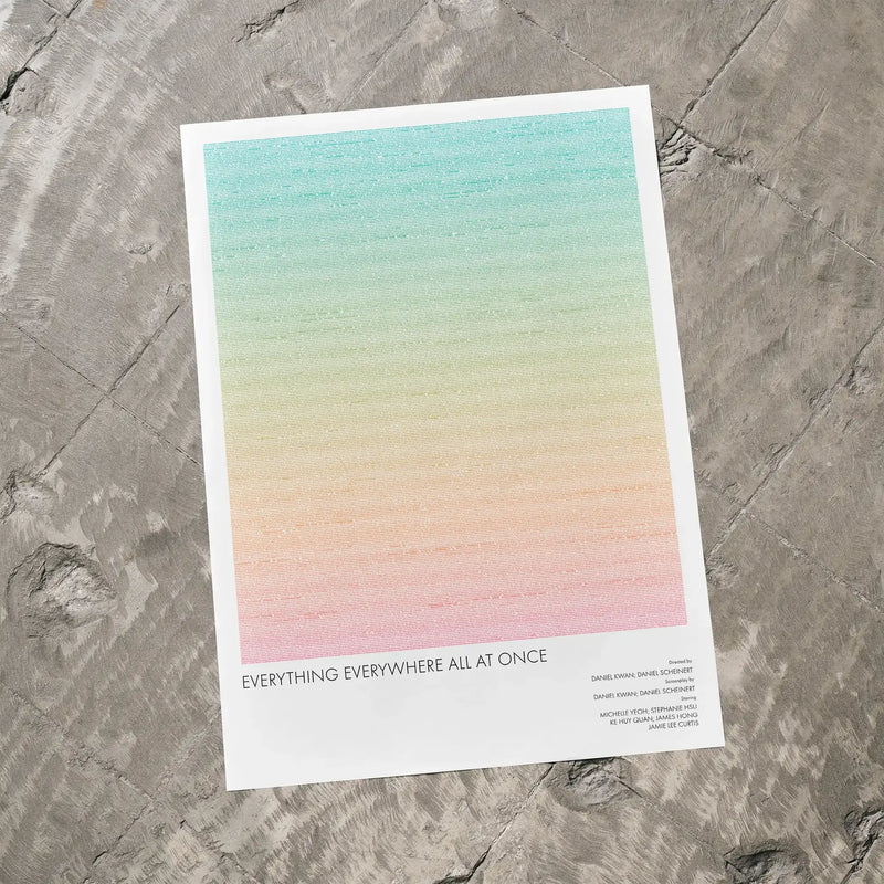 A Everything Everywhere All at Once movie script poster laid flat on a textured floor surface.