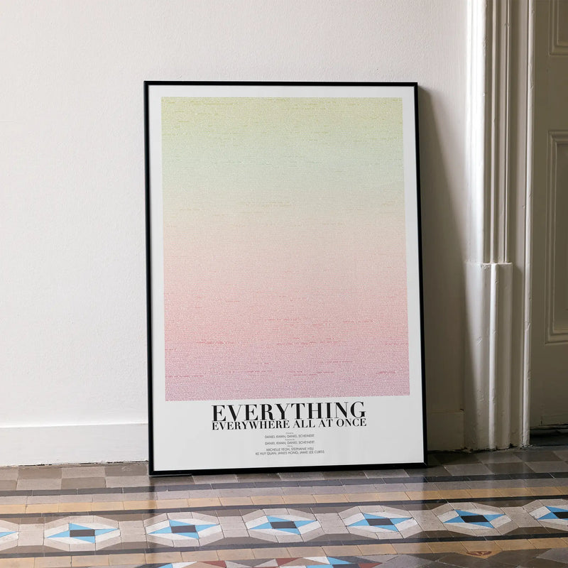 Framed poster for "Everything Everywhere  All At Once" with gradient design and text on a wall.