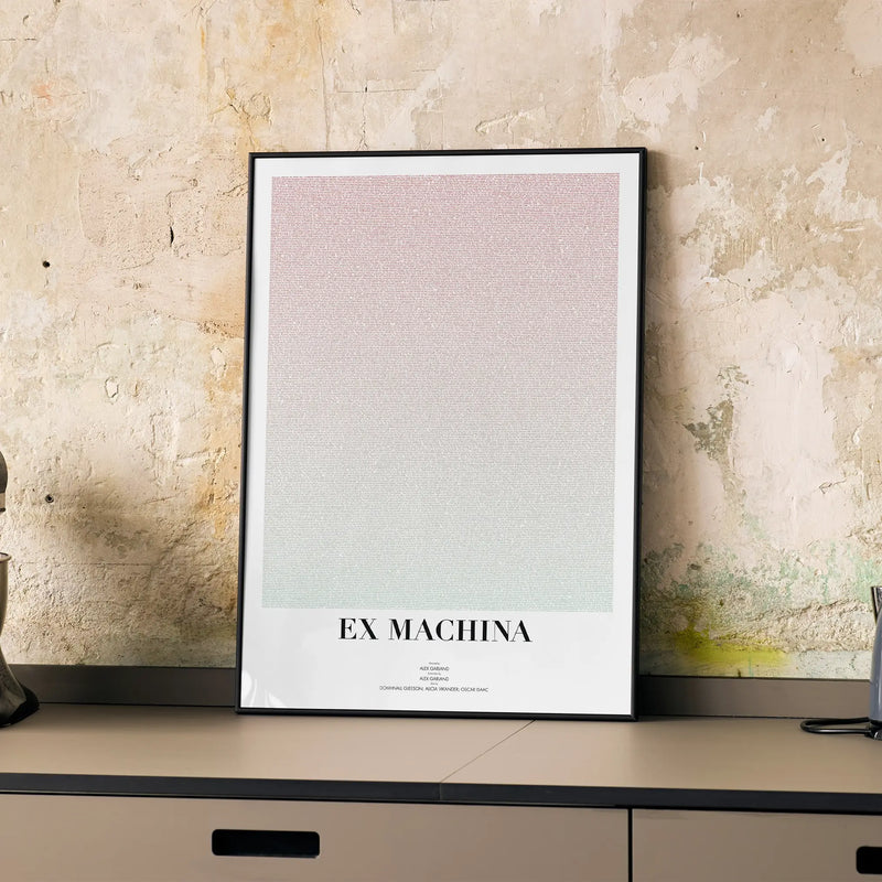 A framed Ex Machina movie script poster displayed on a cabinet in a minimalist interior.