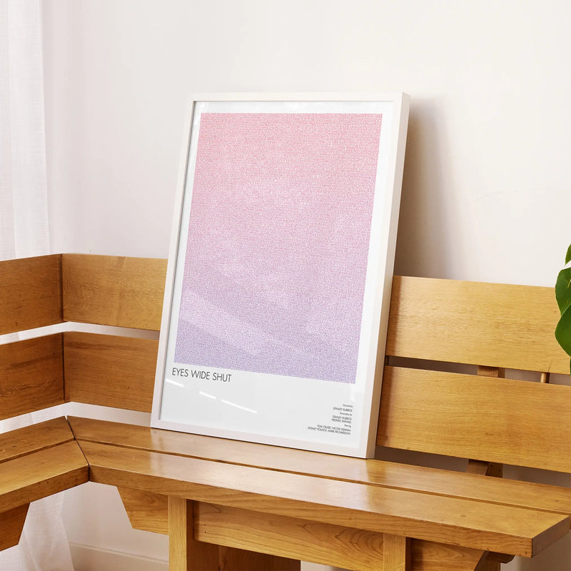 A framed Eyes Wide Shut movie script poster displayed on a sideboard in a contemporary space.