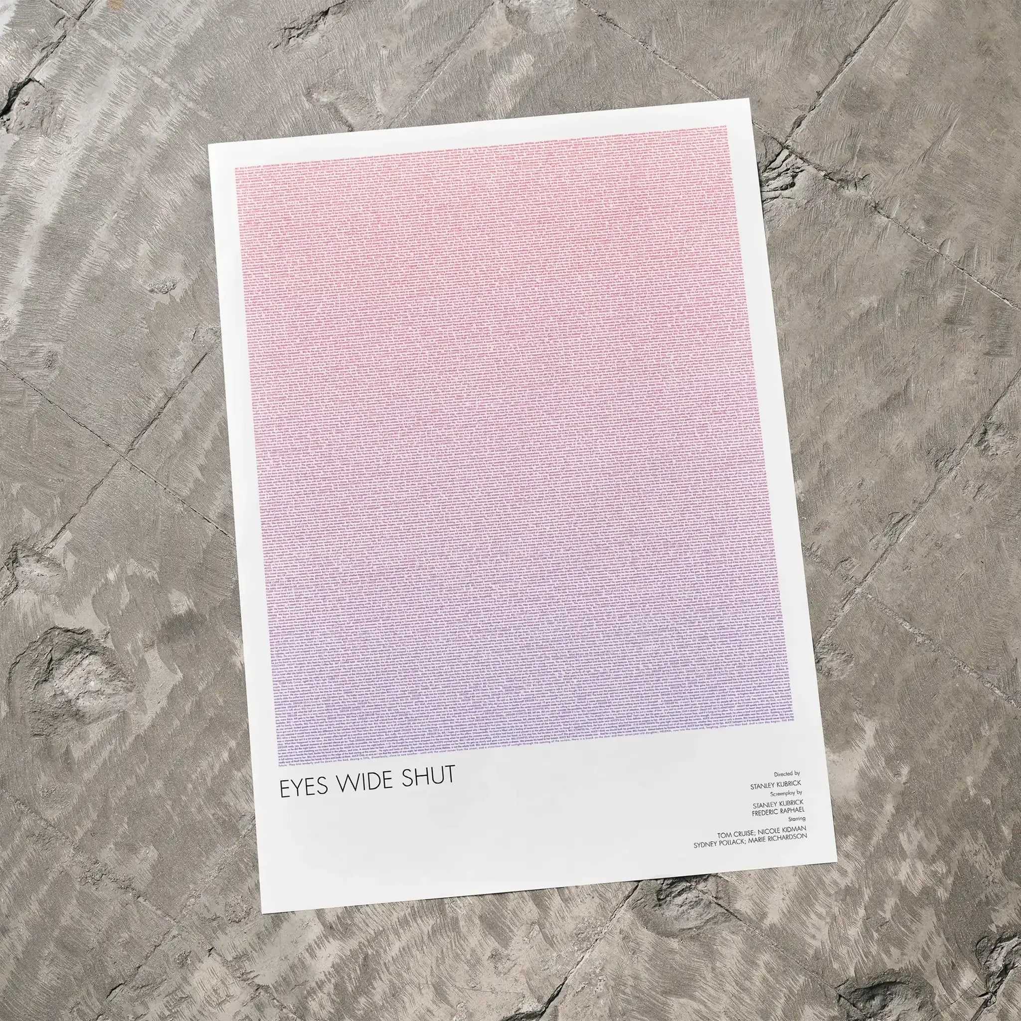 A Eyes Wide Shut movie script poster laid flat on a textured floor surface.