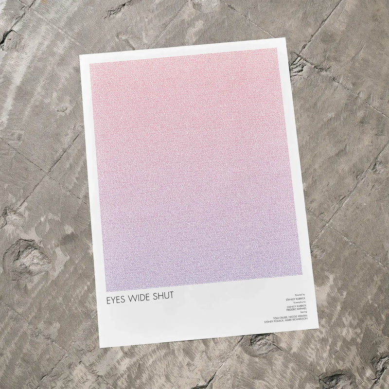 A Eyes Wide Shut movie script poster laid flat on a textured floor surface.