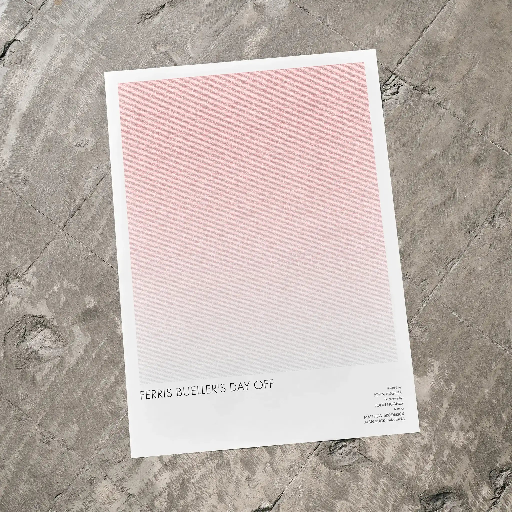 A Ferris Bueller’s Day Off movie script poster laid flat on a textured floor surface.