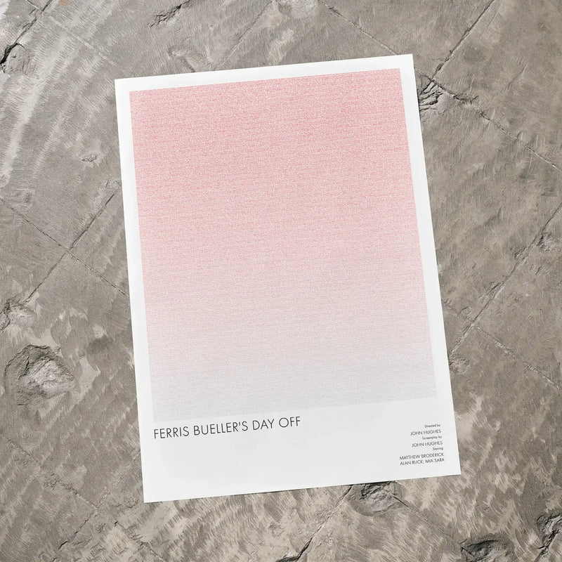 A Ferris Bueller’s Day Off movie script poster laid flat on a textured floor surface.