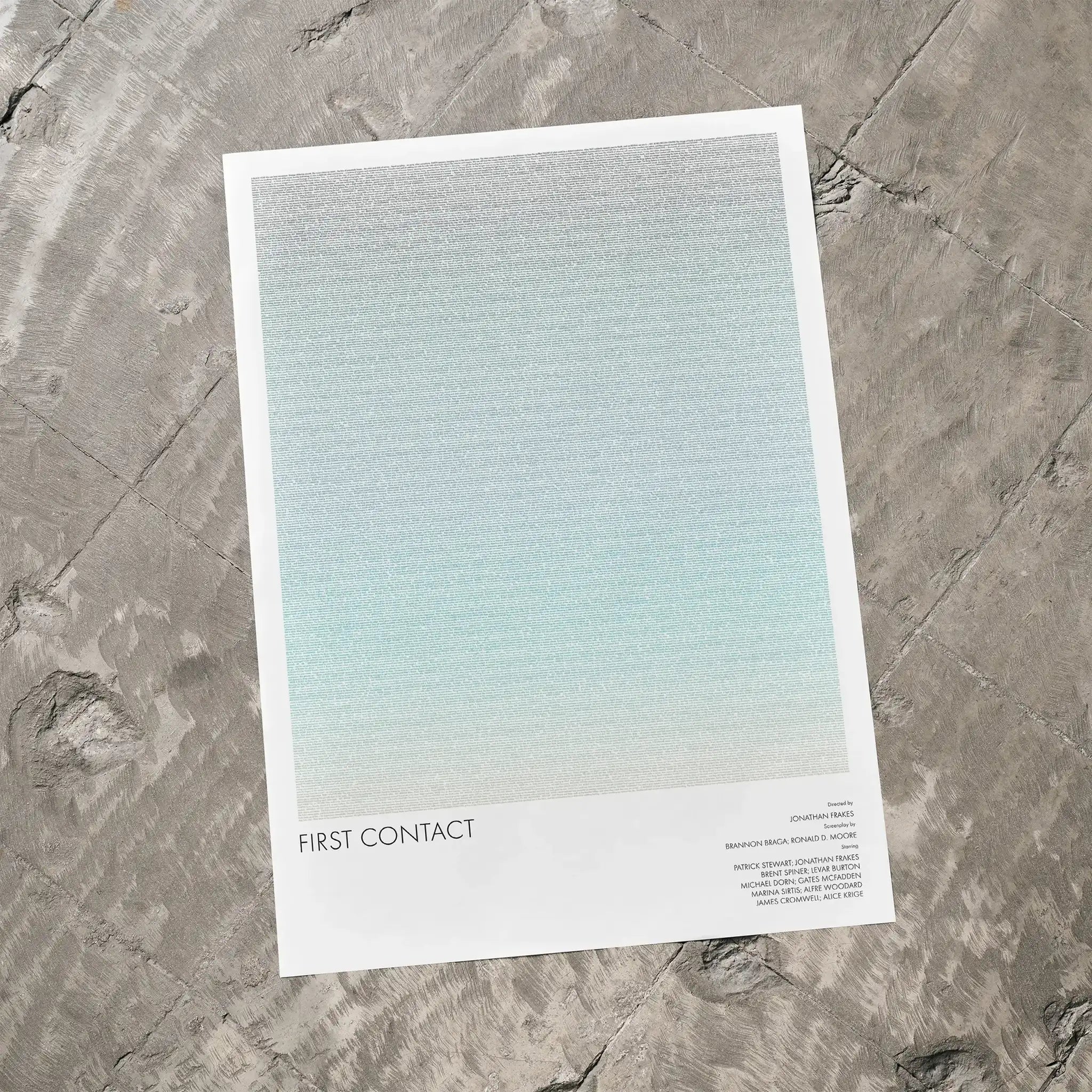 A Star Trek: First Contact movie script poster laid flat on a textured floor surface.
