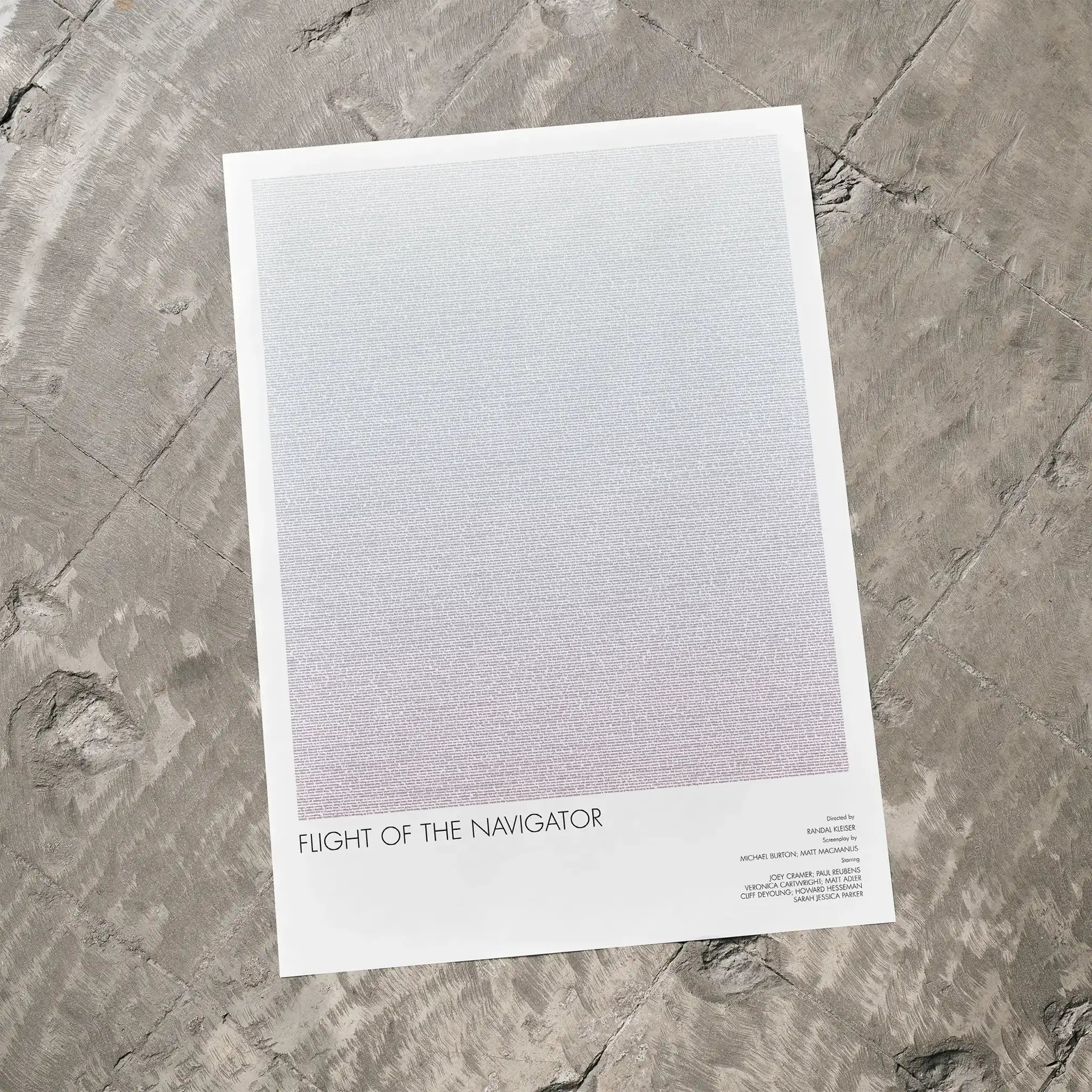 A Flight of the Navigator movie script poster laid flat on a textured floor surface.