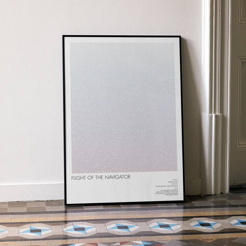 A framed Flight of the Navigator movie script poster leaning against a wall in a minimalist interior.