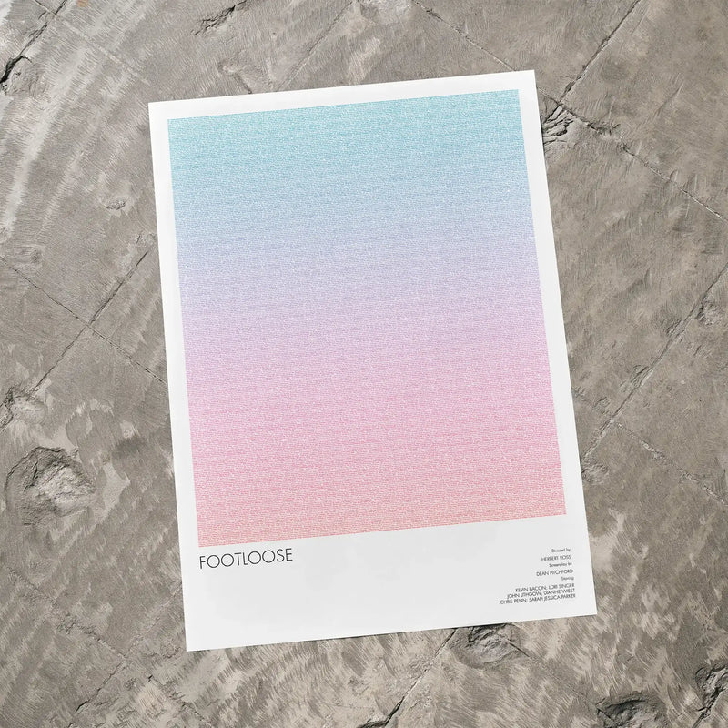 A Footloose movie script poster laid flat on a textured floor surface.