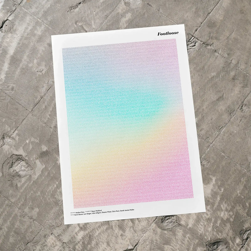 A Footloose movie script poster laid flat on a textured floor surface.