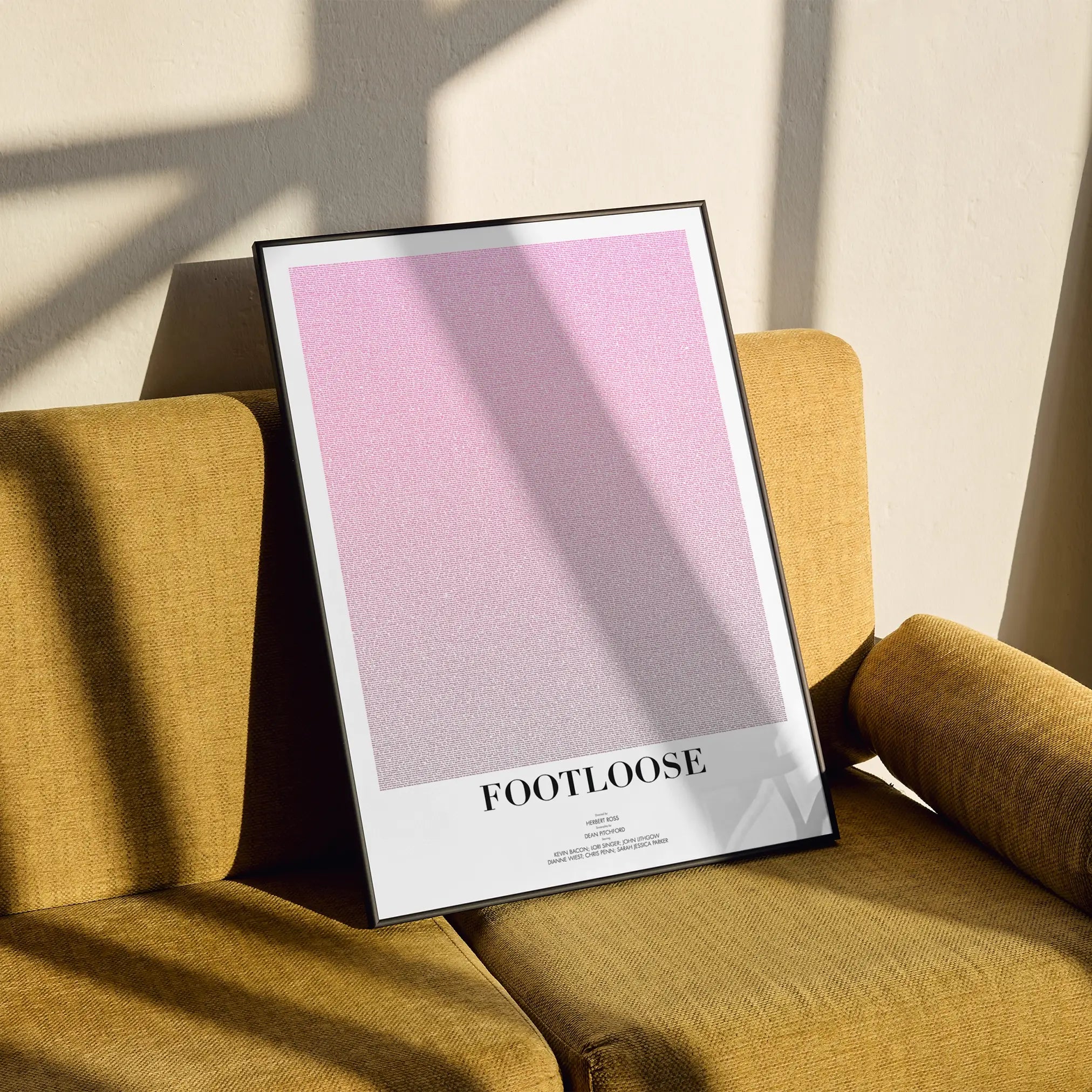 A framed Footloose movie script poster styled in a clean interior setting.