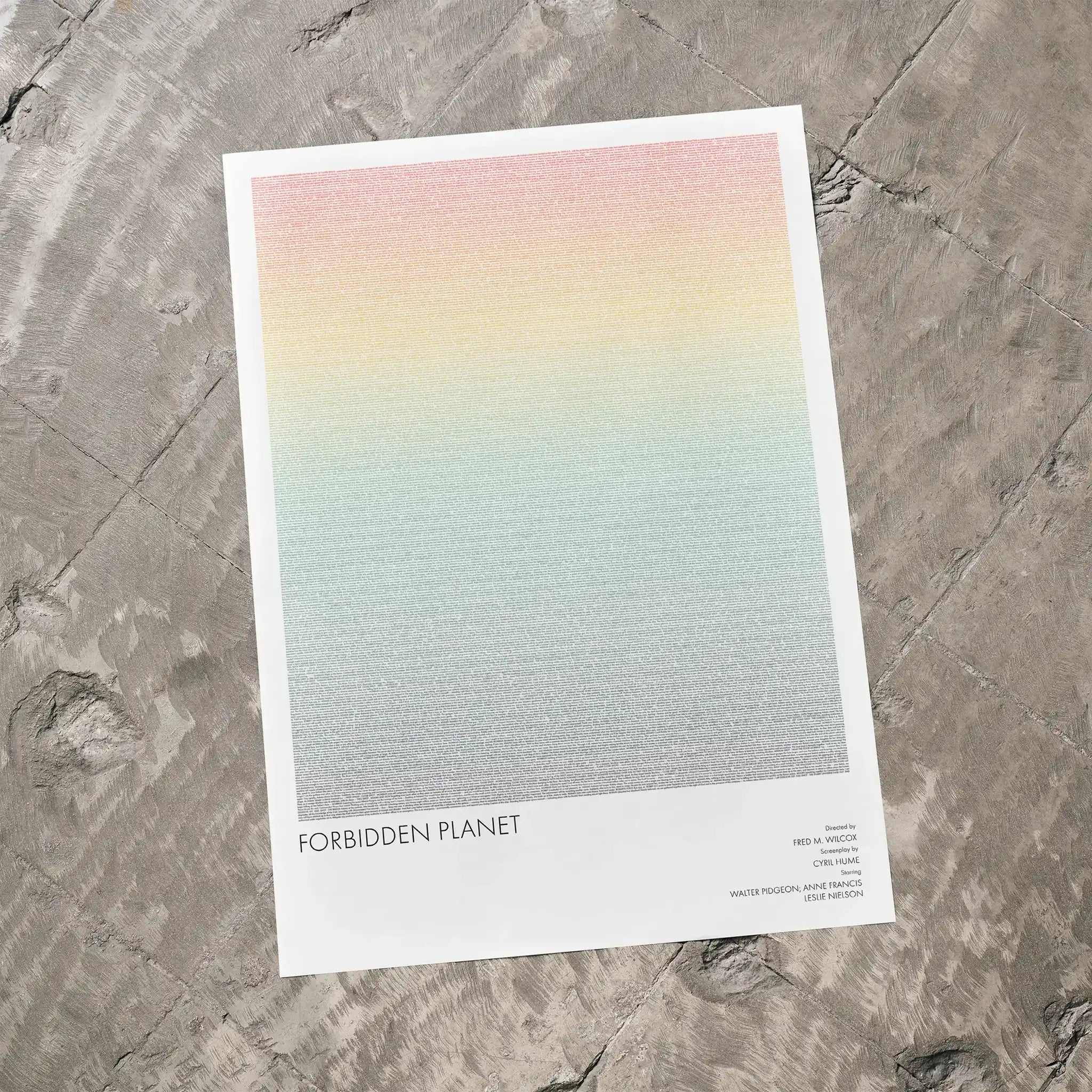 A Forbidden Planet movie script poster laid flat on a textured floor surface.