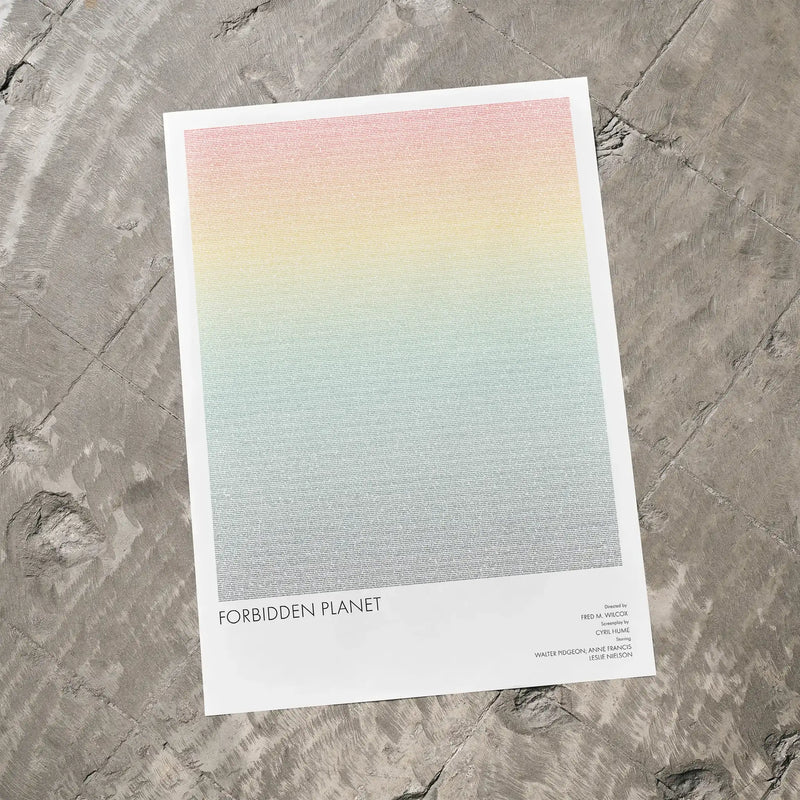 A Forbidden Planet movie script poster laid flat on a textured floor surface.
