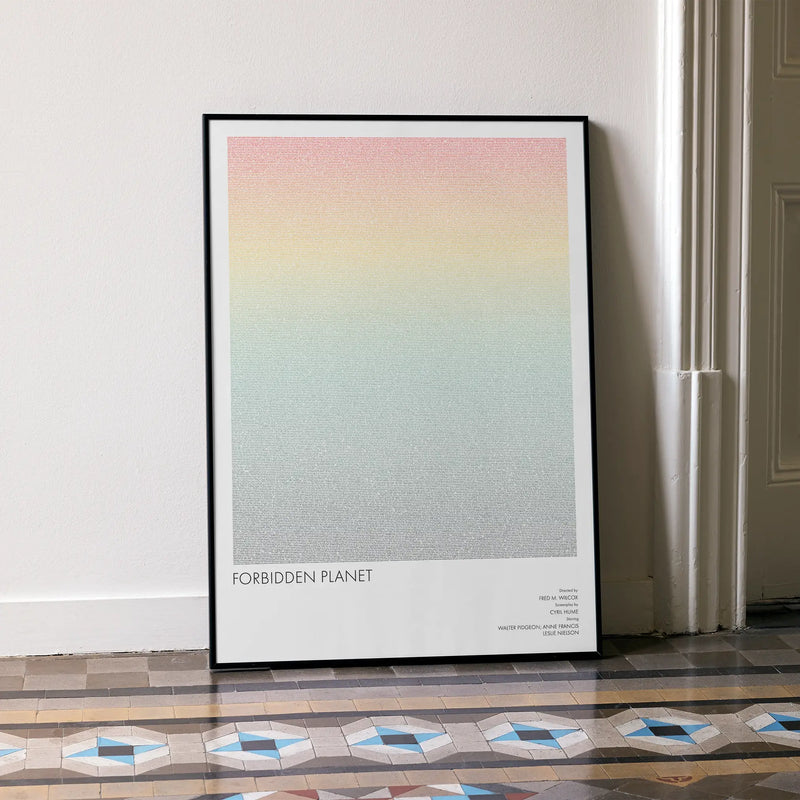 A framed Forbidden Planet movie script poster leaning against a wall in a minimalist interior.