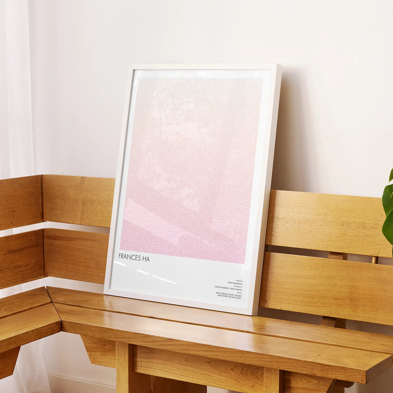 A framed Frances Ha movie script poster displayed on a sideboard in a contemporary space.