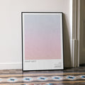 A framed Galaxy Quest movie script poster leaning against a wall in a minimalist interior.
