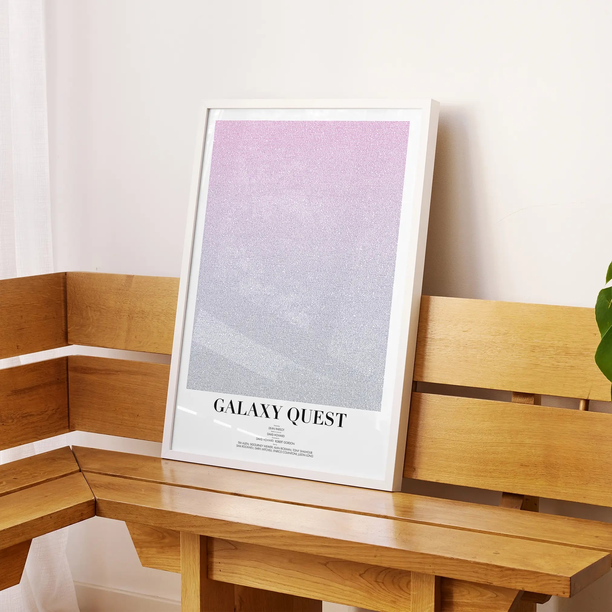 A framed Galaxy Quest movie script poster displayed on a sideboard in a contemporary space.