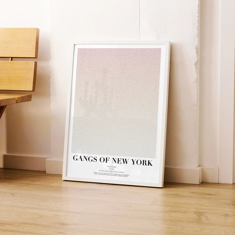 A framed Gangs of New York movie script poster leaning against a wall in a modern interior.