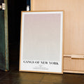 A framed Gangs of New York movie script poster displayed in a contemporary interior setting.