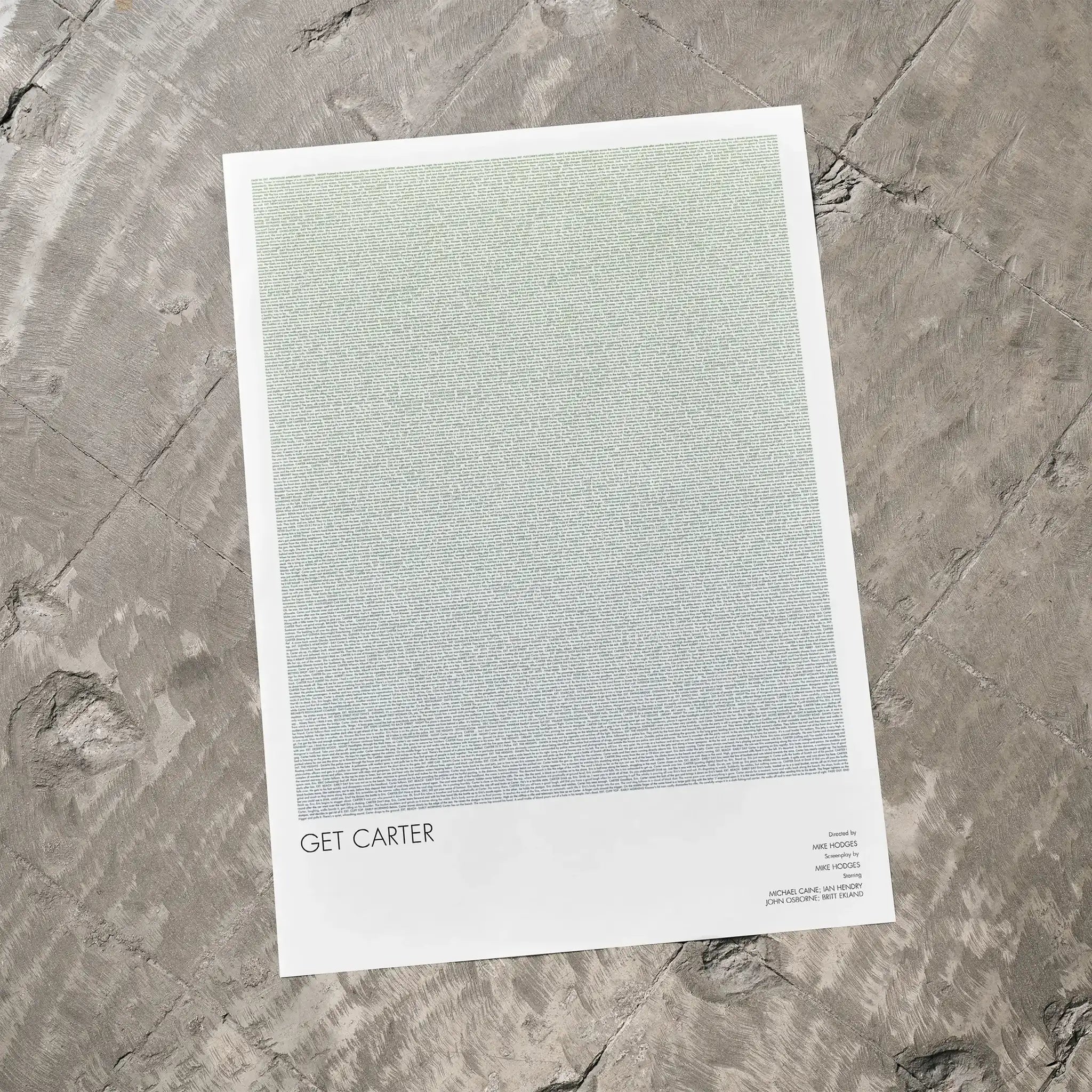 A Get Carter movie script poster laid flat on a textured floor surface.