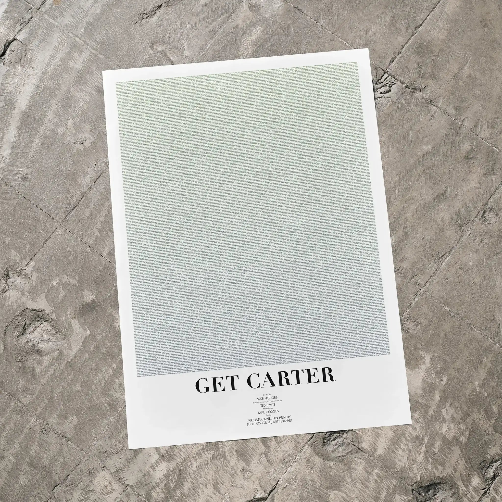 A Get Carter movie script poster laid flat on a textured floor surface.